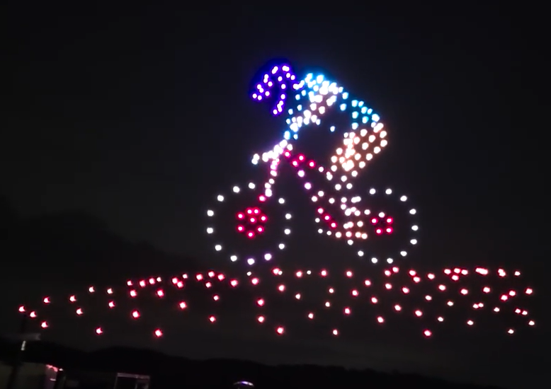 Mountain biker drone light show formation